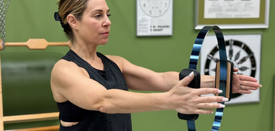 pilates-mat-certification-boca-raton Teacher showing an exercise with Magic Circle during a Pilates Mat Certification in Boca Raton FL